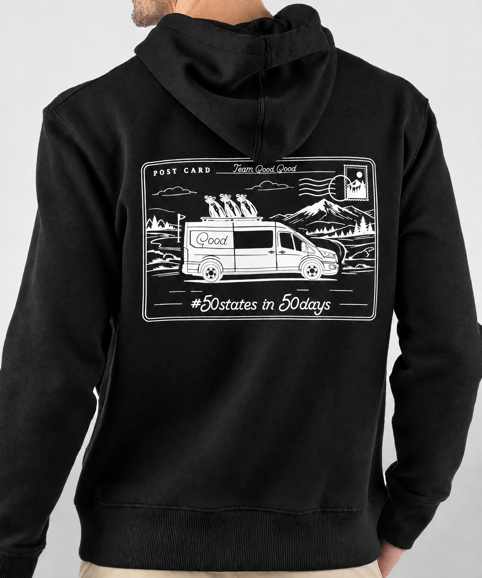 Keep Playing Fleece Hoodie in black, back view on model showing white postcard graphic