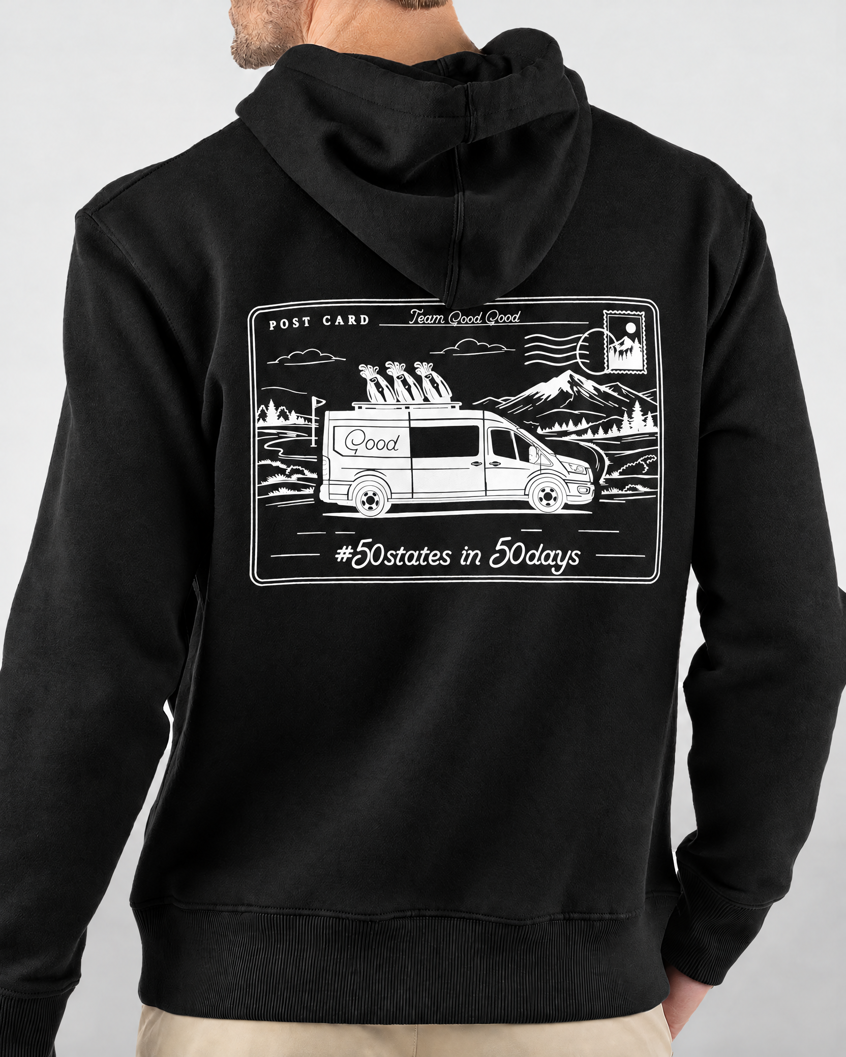 Keep Playing Fleece Hoodie in black, back view on model showing white postcard graphic